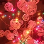 tree with lights and string ornaments by Emily Longbrake